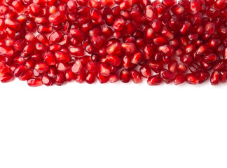 Pomegranate grains on white background copy space