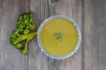 Diet detox food concept. Healthy broccoli soup in bowl . Top view, flat lay