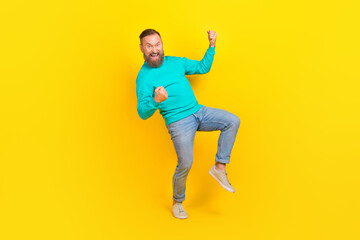 Fototapeta na wymiar Full size photo of handsome granddad excited raise fists celebrate lottery dressed stylish cyan garment isolated on yellow color background
