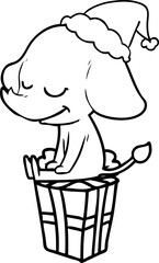 line drawing of a smiling elephant wearing santa hat