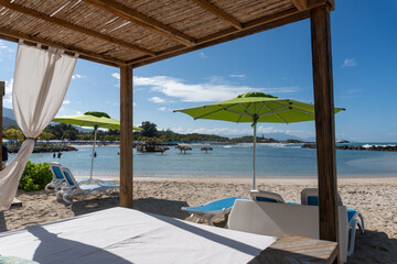 Beach cabanas overlooking the Caribbean Sea. Relax in the shade. Beach, sand, umbrellas, loungers,...