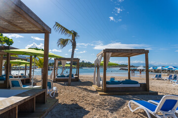 Beach cabanas overlooking the Caribbean Sea. Relax in the shade. Beach, sand, umbrellas, loungers,...