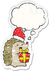 cartoon hedgehog wearing christmas hat and thought bubble as a distressed worn sticker