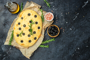 Homemade Italian Focaccia with rosemary and olive on a dark background. banner, menu, recipe place...