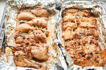 Baked chicken drumsticks without skin and chicken breast. Baked in foil with onions and seasonings. Home cooking. Healthy food, cooked without oil and salt. 