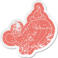 cartoon distressed sticker of a whale wearing santa hat