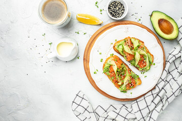 Open sandwiches with salted salmon, guacamole avocado and fresh greens. Delicious breakfast or snack, Clean eating, dieting, vegan food concept. top view. - obrazy, fototapety, plakaty