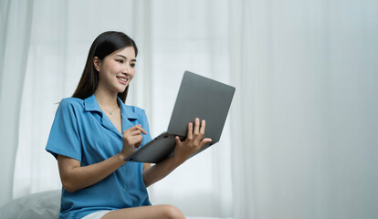 Happy, Relaxing Young beautiful Asian female watching movie or series on notebook in emotional...