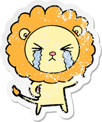 distressed sticker of a cartoon crying lion
