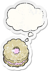 cartoon biscuit and thought bubble as a distressed worn sticker