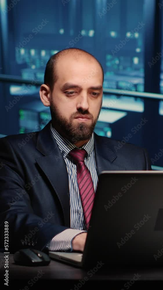 Poster vertical video: server technician specialist working on laptop running networking diagnostics on cyb