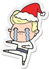 sticker cartoon of a man crying wearing santa hat