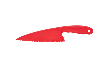plastic knife of red color for cutting a cake on a white background