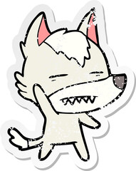 distressed sticker of a cartoon wolf waving showing teeth