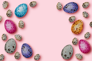Frame of colorful and quial eggs on pastel background, copy space. Top view, flat lay. Happy Easter eggs concept