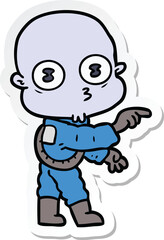 sticker of a cartoon weird bald spaceman pointing