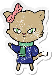 distressed sticker of a cute cartoon cat in winter clothes
