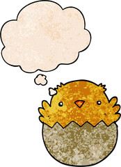 cartoon chick hatching from egg and thought bubble in grunge texture pattern style