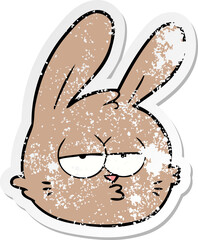distressed sticker of a cartoon jaded rabbit face