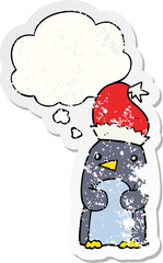 cute christmas penguin and thought bubble as a distressed worn sticker