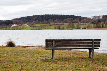 lonely wooden bench by the lake