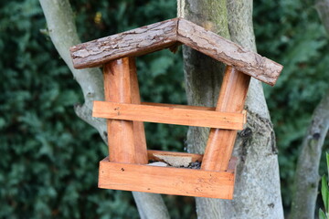 Small wooden house for feeding birds in winter