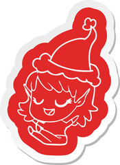 happy cartoon  sticker of a elf girl sitting wearing santa hat