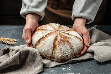 Female hands holding Homemade sourdough bread. Culinary, cooking, bakery concept