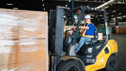 Warehouse worker workers with forklift in a warehouse. Use forklift operator moves packages....