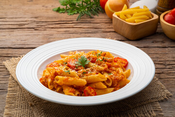 Penne macaroni with Meat Sauce,Easy Penne pasta tossed with a simple tomato sauce with ground pork in white plate