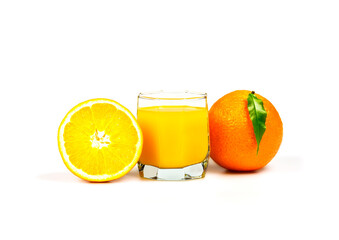 A glass of orange juice, whole and half orange on white background