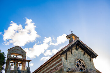 Church in altos de chavon with cross on the dome blue sky and stained glass windows