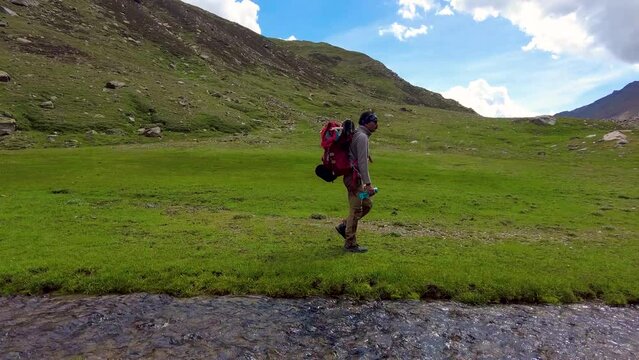 Video of Man walking beside a stream in Ghepan Ghat, Lahaul, Himachal Pradesh