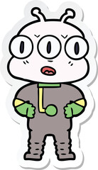 sticker of a cartoon three eyed alien