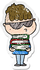 distressed sticker of a cartoon boy wearing sunglasses with stack of books