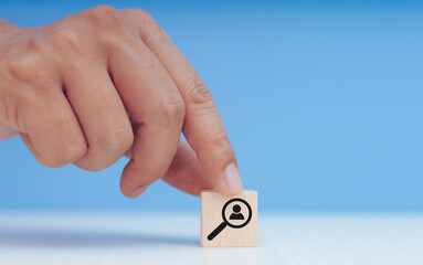 wooden block and person icon and magnifying glass