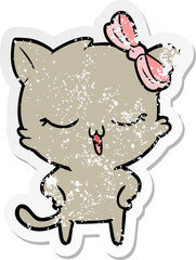 distressed sticker of a cartoon cat with bow on head and hands on hips