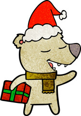 textured cartoon of a bear with present wearing santa hat