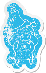 happy cartoon distressed sticker of a pig wearing santa hat