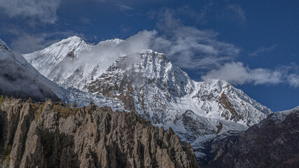View of the high altitude plateau with Annapurna range in clouds (in the background) on the approach to Manang village, Manang district, Around Annapurna trek, Nepal Himalayas, Nepal
