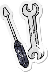 distressed sticker cartoon doodle of a spanner and a screwdriver
