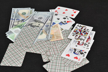 Fototapeta na wymiar On the card table were left lying mixed with each other cards and money.