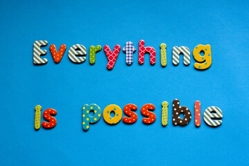 colored text everything is possible on blue paper background