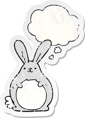 cartoon rabbit and thought bubble as a distressed worn sticker