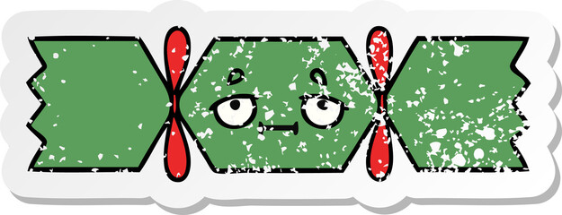 distressed sticker of a cute cartoon christmas cracker