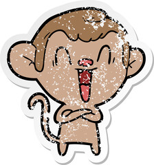 distressed sticker of a cartoon laughing monkey