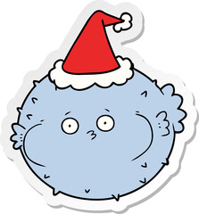 sticker cartoon of a puffer fish wearing santa hat