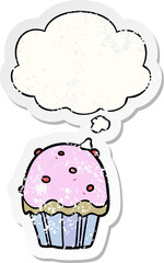 cartoon cupcake and thought bubble as a distressed worn sticker