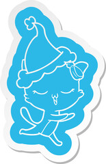 cartoon  sticker of a cat with bow on head wearing santa hat