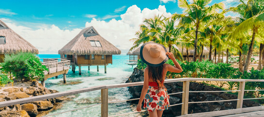 Tahiti hotel woman tourist at resort by beach. Vacation travel in Bora Bora, French Polynesia landscape. Happy elegant lady tourist enjoying summer holiday - obrazy, fototapety, plakaty